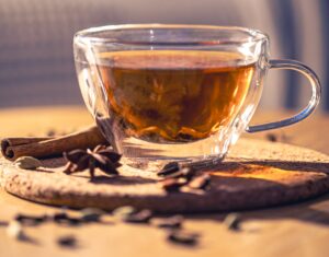 fragrant black tea with spices on the table, close up.